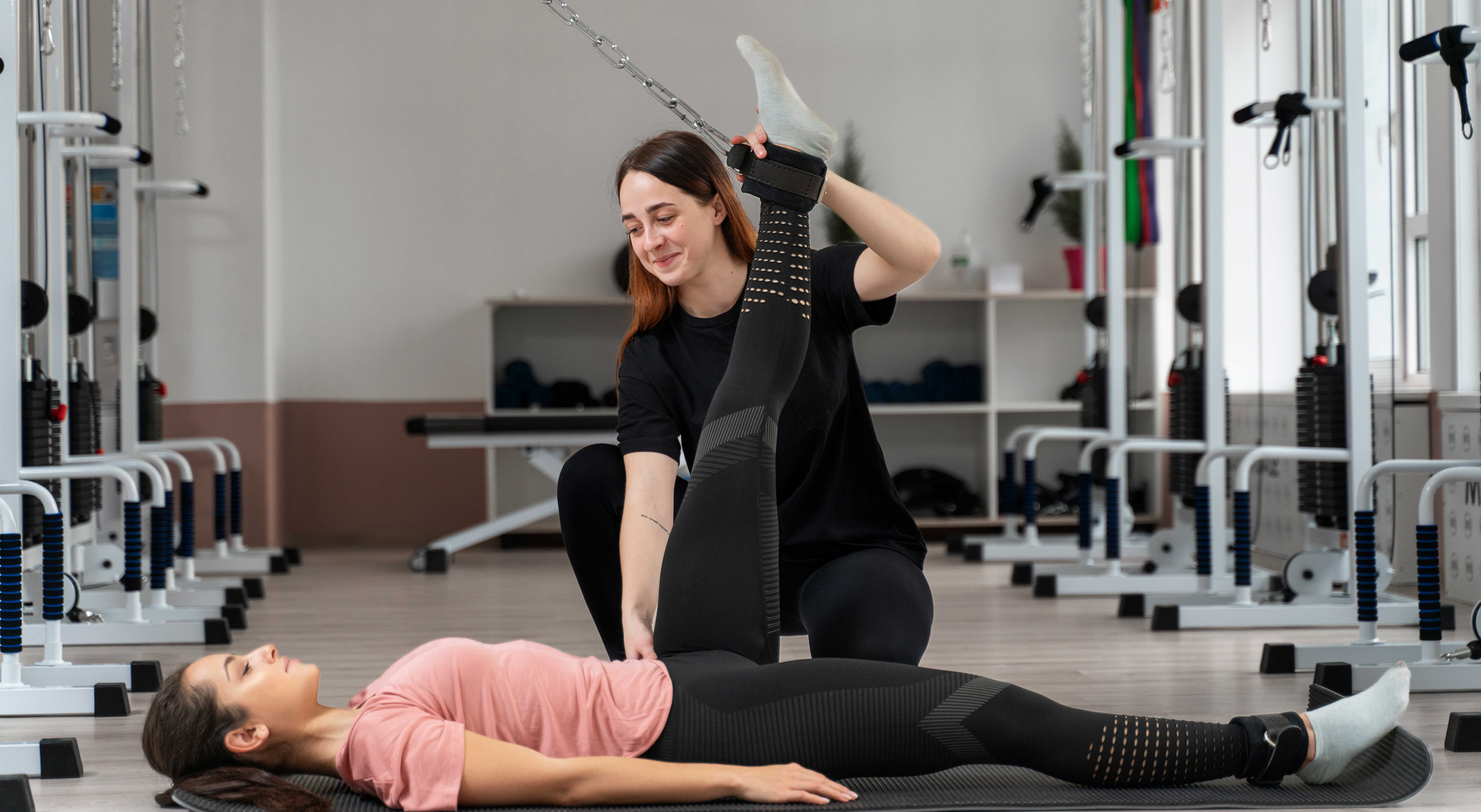 Physiotherapist guiding a patient through an assisted leg stretch